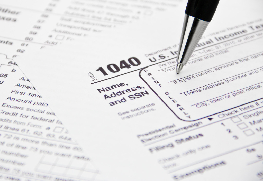 IRS tax form being filled out with a pen