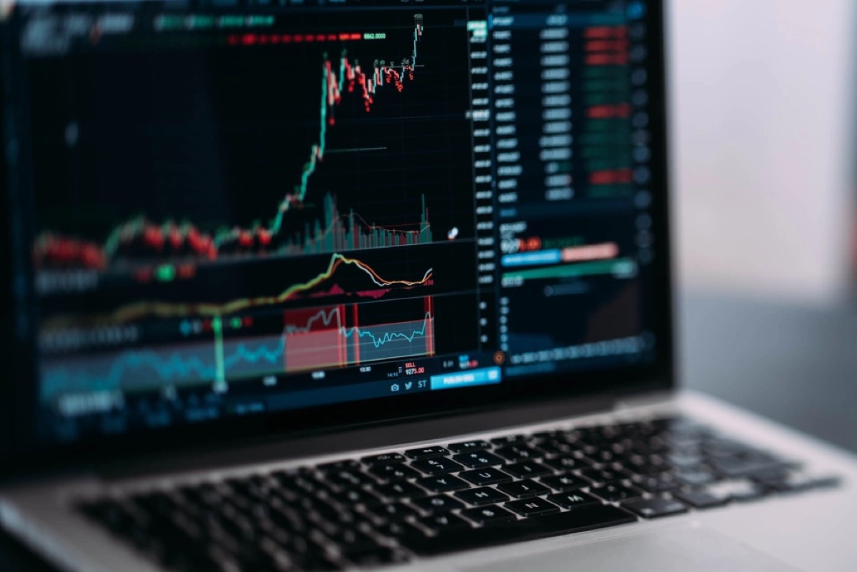 A trading panel of live price quotes on a laptop screen, illustrating how crypto price trackers publish figures they infer rather than observe