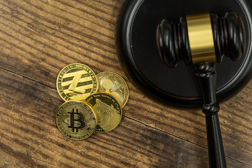 Bitcoin coins beside a gavel and legal documents, illustrating cryptocurrency division in a divorce