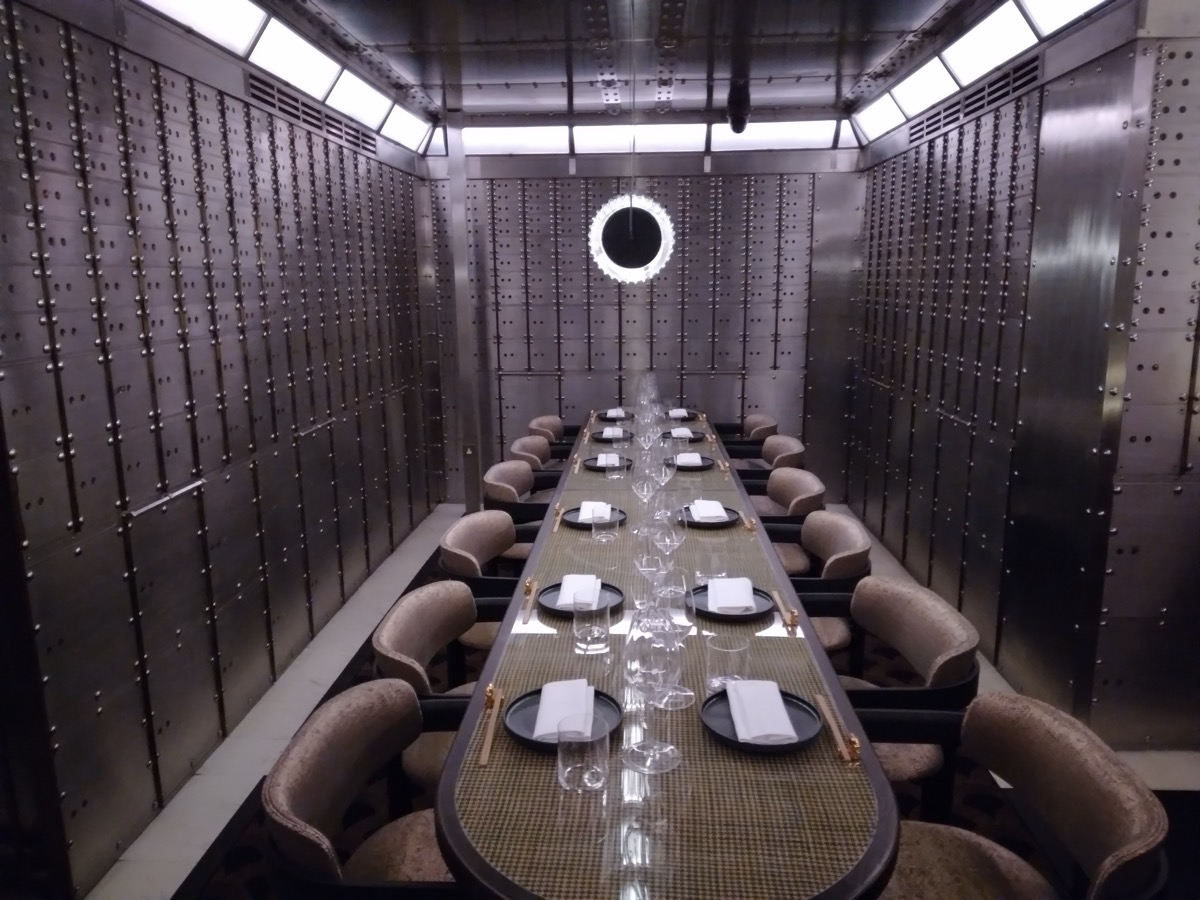 An underground bank vault with a heavy steel door, illustrating custody control over pledged digital assets