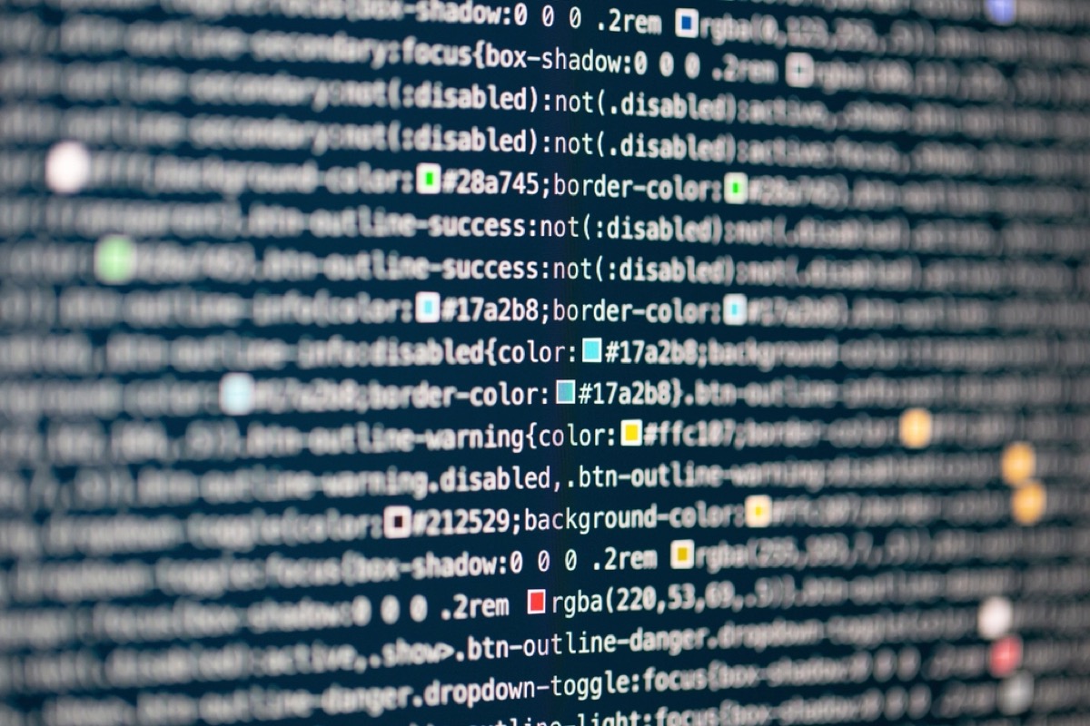 Lines of code on a screen, standing in for the smart contract that keeps compounding interest on a defaulted loan