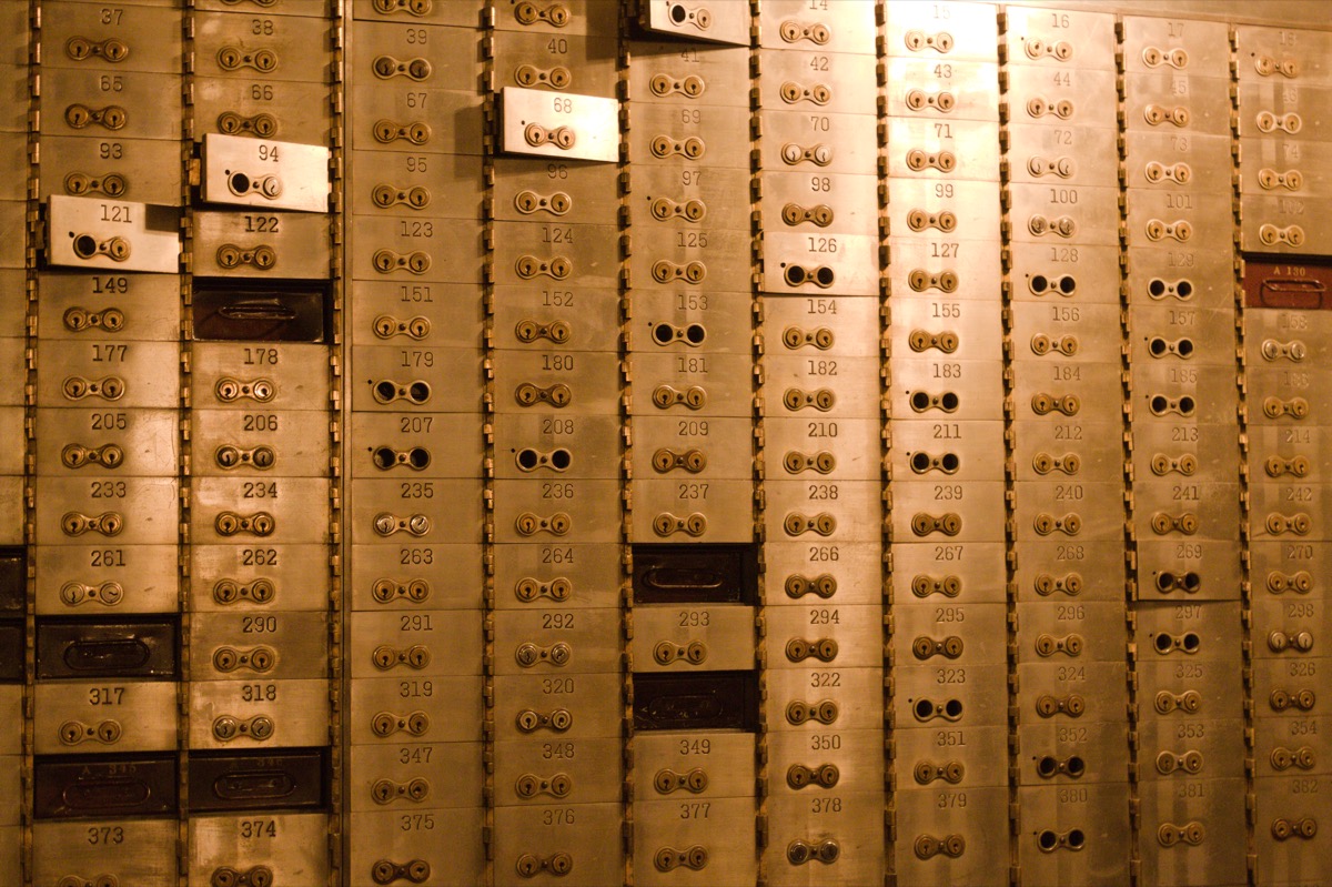 Rows of closed safe deposit boxes, representing tokens held under a one-year lock