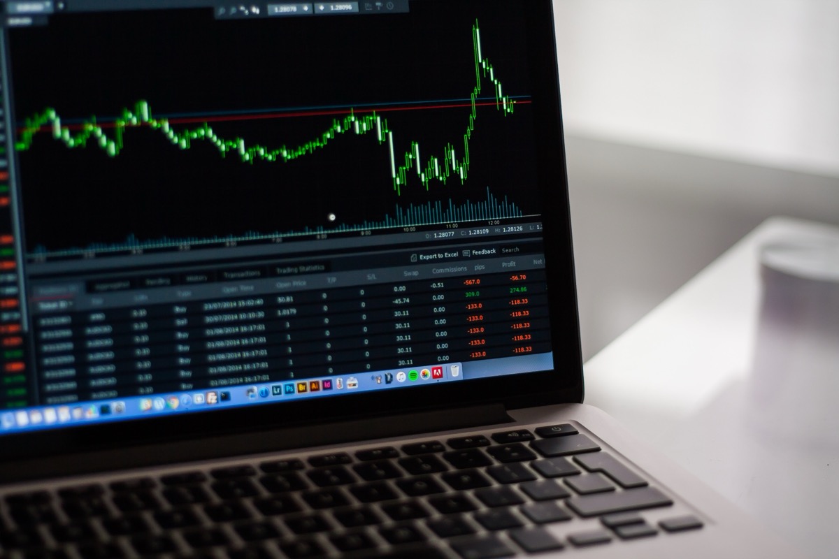 A blurred financial price chart on a screen, illustrating market data for two tokens sharing one ticker symbol